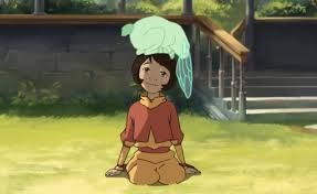 a green dragonfly bunny spirit sits on top of Jinora's head