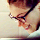 Cosima laughing in a white lab coat