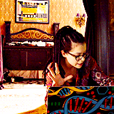 Cosima on her laptop gesturing in exasperation