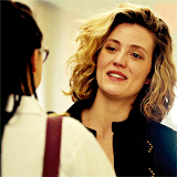 Cosima and Delphine shake hands and smile at each other