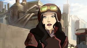 Asami wearing a two tone red jacket with an open neck and wide lapels, she has goggles on top of her head and he long dark hair is loose