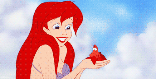 Ariel the mermaid kissing Sebastian the crab