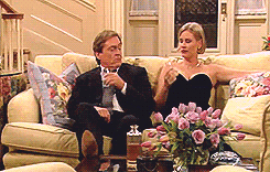 image of two characters on a sofa toasting with glasses and drinking the alcohol in unison