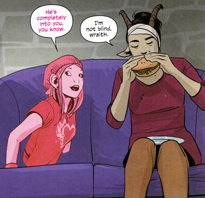 Izabel and Klara talk while Klara eats a sandwich. Izabel floats inside the couch Klara is sitting on.