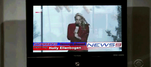 woman in storm getting hit by a stop sign