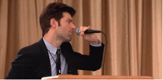man dropping a microphone and walking offstage