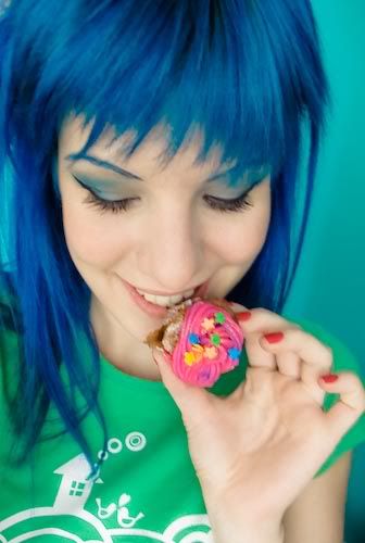 Green haired girl holding cupcake