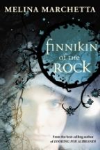 Cover of Finnikin of the Rock, showing a semi-transparence face of a boy over a blue background