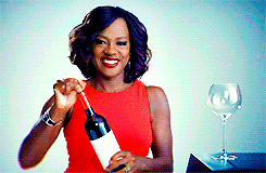 Viola Davis showered with confetti and then raising a glass of wine to the viewer in a celebratory toast
