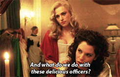 Mina and Lucy are in a bedroom - caption reads And what do we do with these delicious officers