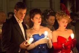 Jonathan, Mina and Lucy in formal atire at Dracula's first ball - they are each holding a glowing lightbulb