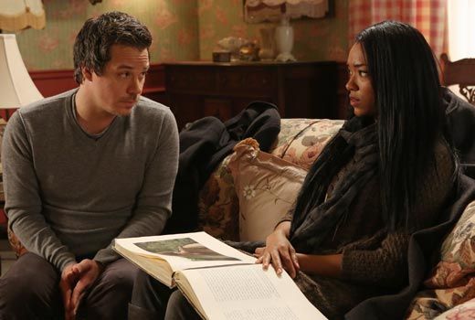 Neal and Tamara are sitting together looking at Henry's book of fairy tales