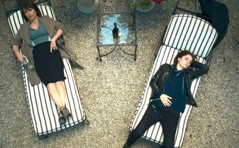 Quinn King and Rachel Goldberg lying on striped sun loungers