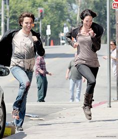 Lena Headey & Thomas Dekker run through a scene grinning